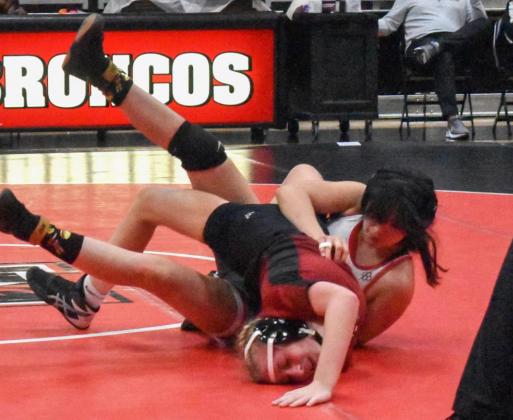 Cheyenne Reyman attempts to pin her opponent from Tuttle during Mustang’s regular-season finale. The Lady Broncos will compete next Feb. 14 and 15 at the regional tournament. Photo / Michael Kinney