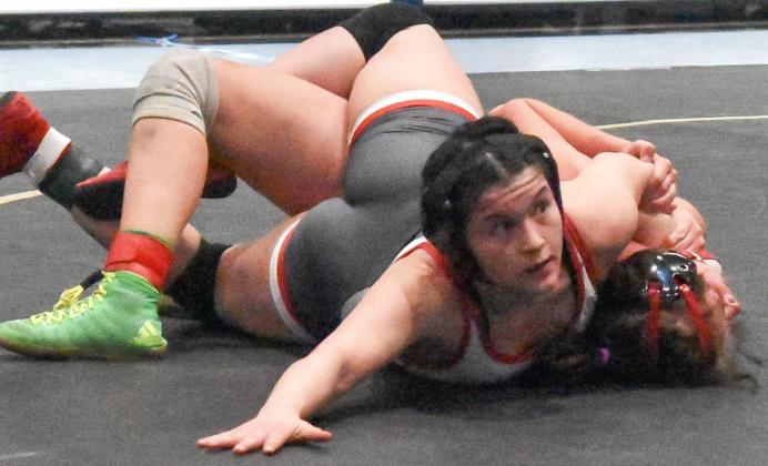 Mustang’s Mia Cayard tries to pin Yukon’s Jocelyn Neal Tuesday at the regional wrestling tournament at Noble High School. Cayard is the only girl wrestler to represent Mustang at state. Photo / Michael Kinney