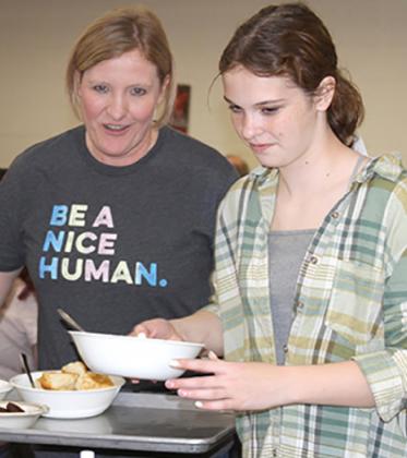 Debi Knecht, left, and her daughter Blake serve biscuits, gravy and sausage during the first shift of the 65th Annual Ground Hog Dinner Saturday morning. The event is hosted by the Methodist Men’s Group. Photo / Michael Pineda