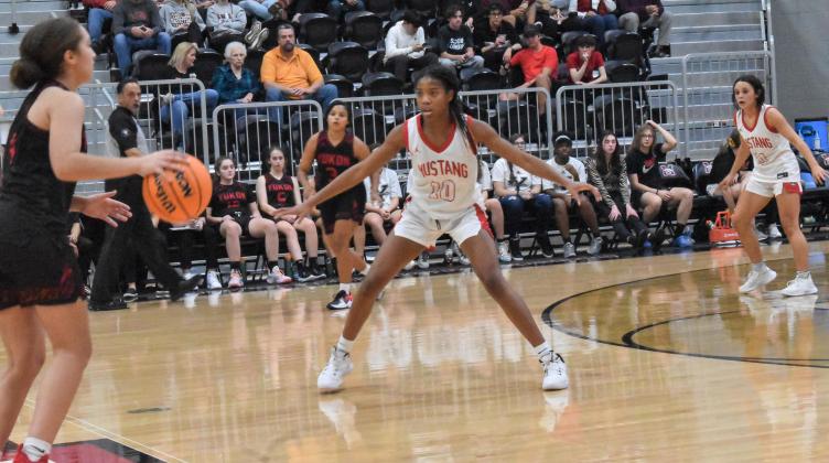 Bronco freshman guard Cherish Haywood sets up defensively against a Millerette. Mustang High School’s girls basketball team rolled over rival Yukon in a 66-40 win Tuesday night. Photo / Michael Kinney