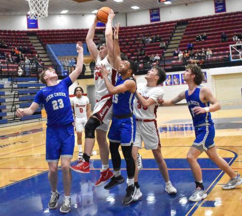 Jacob Henderson pulls down a rebound for Mustang Monday in the regional tournament at Moore High School. The Broncos lost to the Antlers by one point, which ended their season. Photo / Michael Kinney