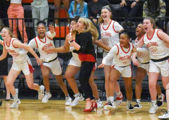 The Mustang High School girls basketball team celebrates after their 49-34 victory against Choctaw March 5. The Lady Broncos are ready to win it all with their first state matchup against Tulsa Union this week. Union knocked Mustang out of state competition last year. Photo / Michael Kinney