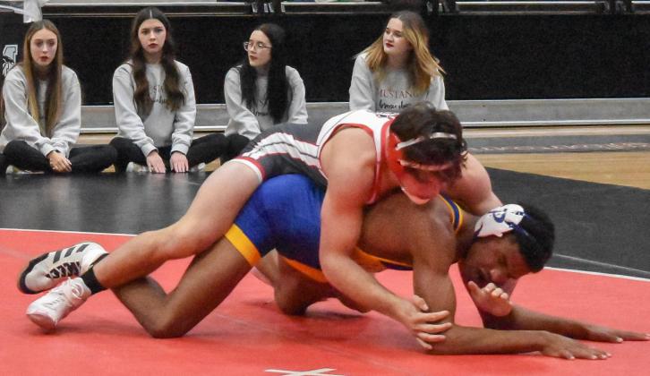 John Wiley prepares to pin his Piedmont opponent Dec. 9 during a Mustang victory. The senior said he is prepared for more victories throughout his last season. Photo / Michael Kinney